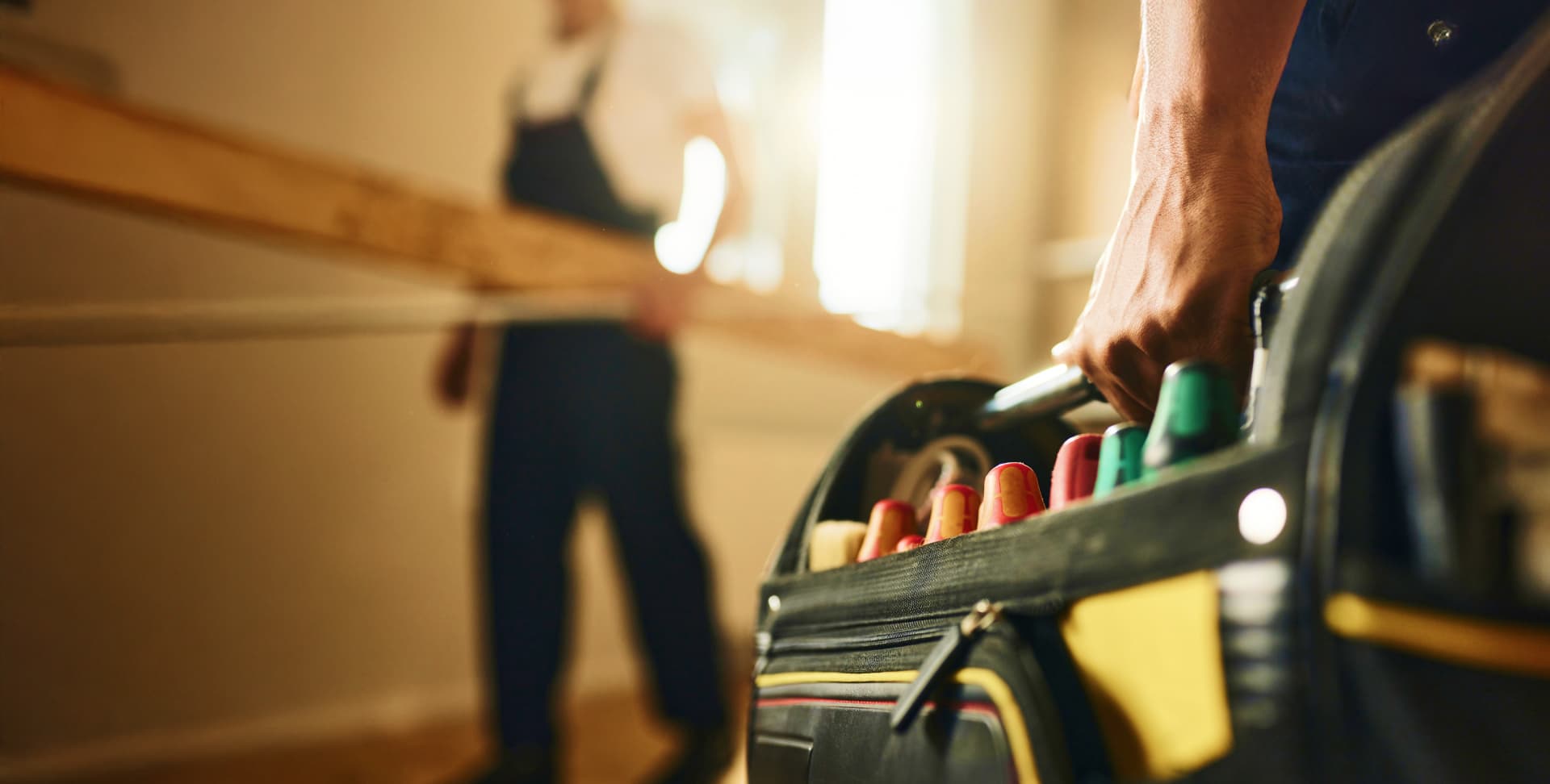 Electrician carrying tool bag