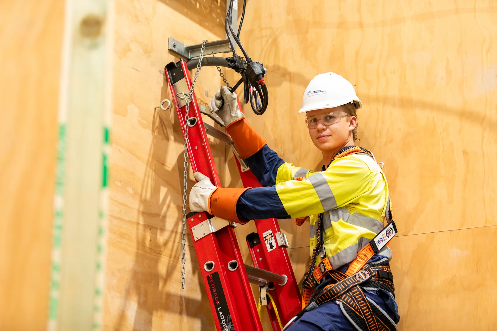 NECA Electrical Apprentice Preparing for Ladder Safety and Installation Tasks